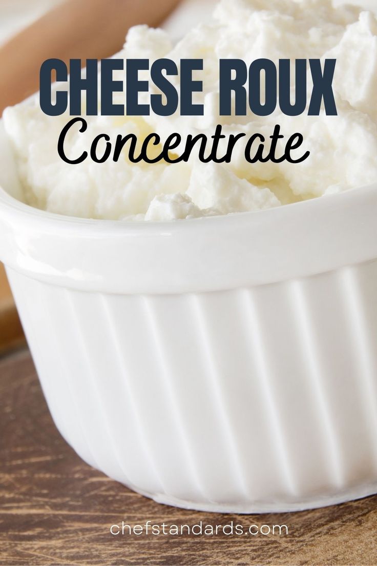 a white bowl filled with cottage cheese on top of a wooden table