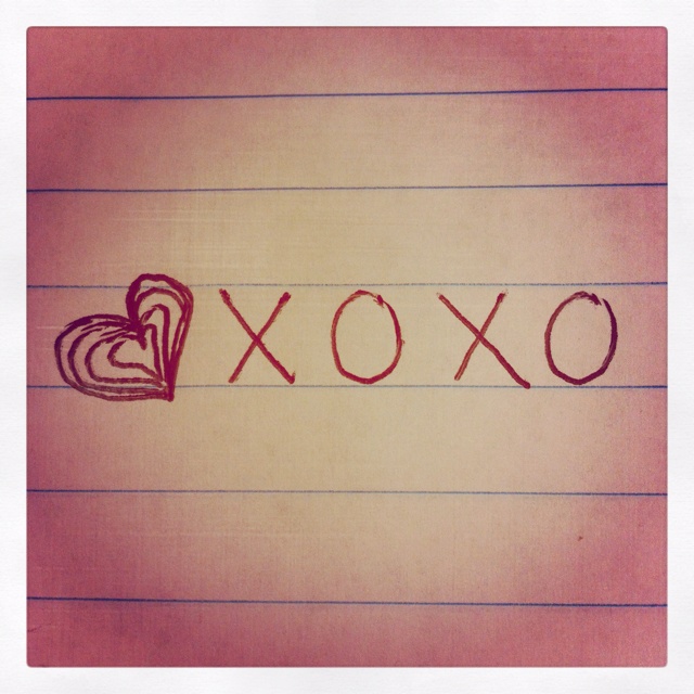 the word xoxo is written in red ink on lined paper with a heart