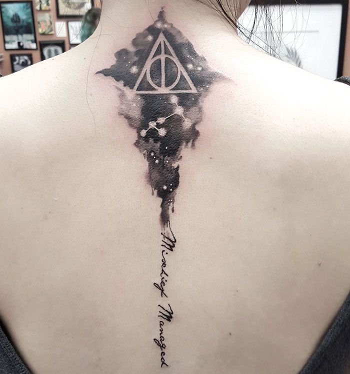 a woman with a harry potter tattoo on her back