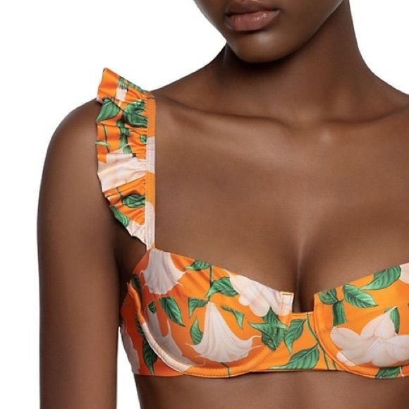 From The Curandera Collection. Agua By Agua Bendita's Bikini Top In A Floral Print Features Ruffle Trim At The Straps. Sweetheart Neck Sleeveless Pullover Style 81% Polyester/19% Lycra Hand Wash Orange Tropical Print Swimwear For Spring, Orange Tropical Print Swimwear For Beach Season, Orange Underwire Swimwear For Summer, Orange Tropical Swimwear For Sunbathing, Orange Summer Swimwear For Sunbathing, Orange Summer Swimwear For Poolside, Coral Beachwear For Poolside, Coral Summer Swimwear For Poolside, Orange Tropical Swimwear For Beach Party