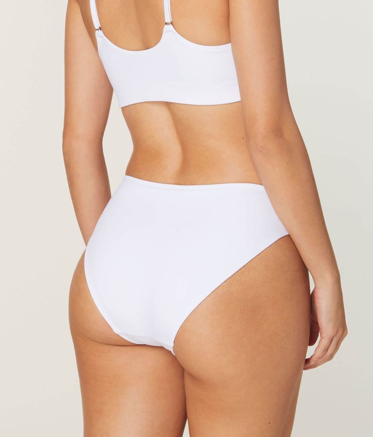 Our most versatile low rise bottom. A classic fit, made to mix or match.FIT EXPERTS SAY:"Makes my legs look longer!" Minimal Stretch White Swimwear For Beach, White Swimwear For Beach, White High-waist Swimwear With Built-in Bra, White Seamless Swimwear For Beachwear, White Seamless Beachwear Swimwear, White Seamless Bottoms With High-cut Leg, White Seamless High-cut Leg Bottoms, Basic White Sports Bottoms, White Micro-elastic Bottoms For Sports