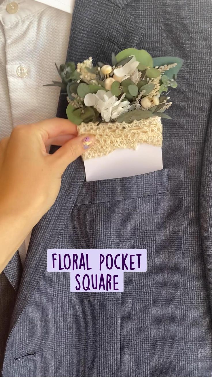 a person in a suit and tie is holding a flower pocket square with the words floral pocket square written on it