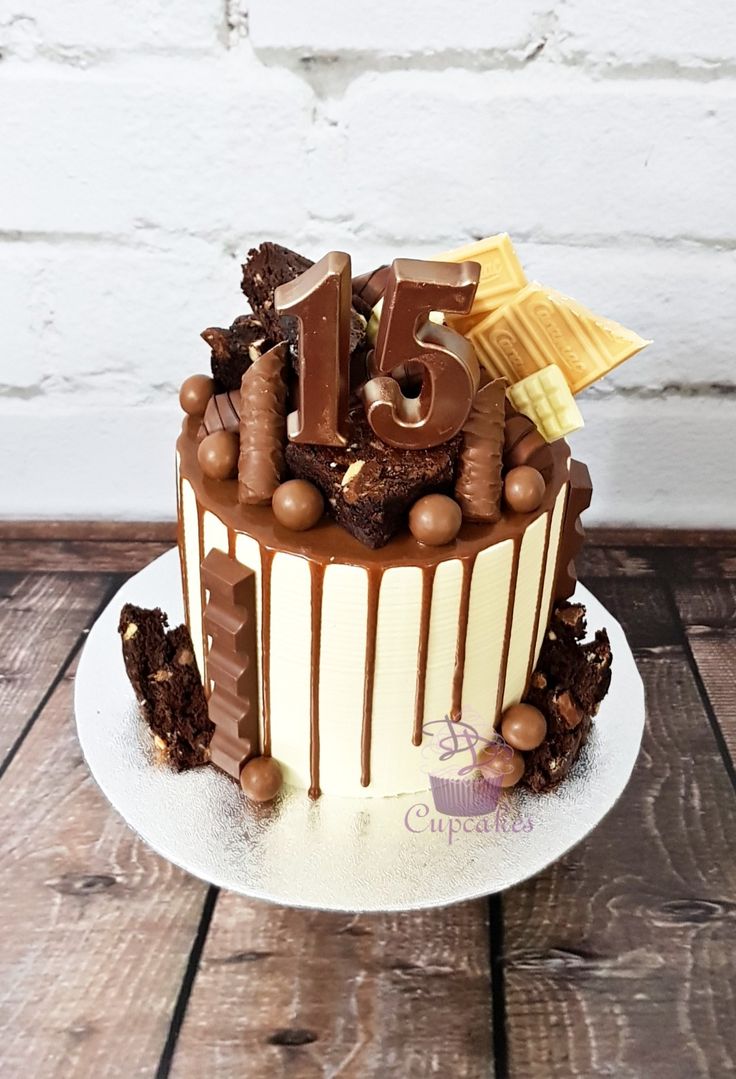 a birthday cake with chocolate frosting and decorations