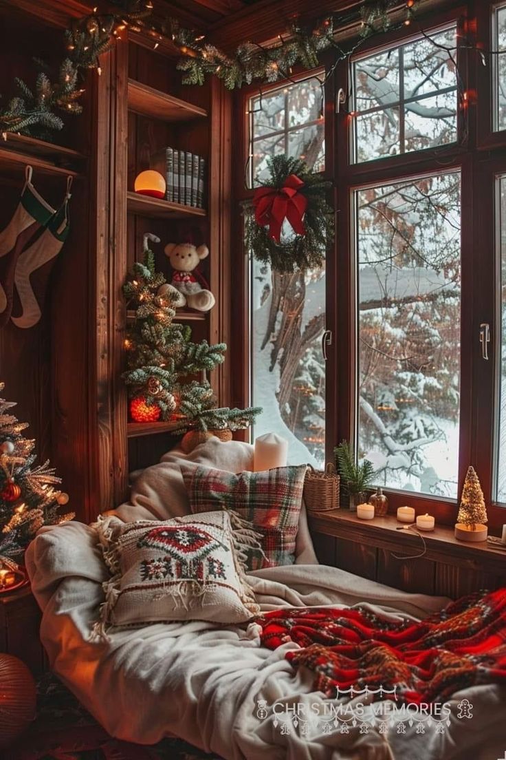 a living room filled with christmas decorations next to a large window covered in snow and stockings