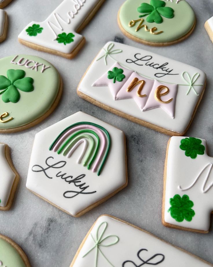 some decorated cookies are sitting on a table with st patrick's day messages and shamrocks