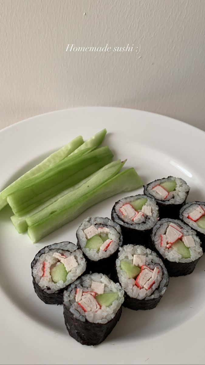 sushi and celery on a white plate