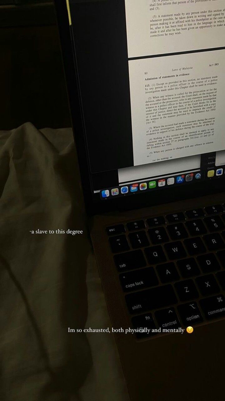 an open laptop computer sitting on top of a bed