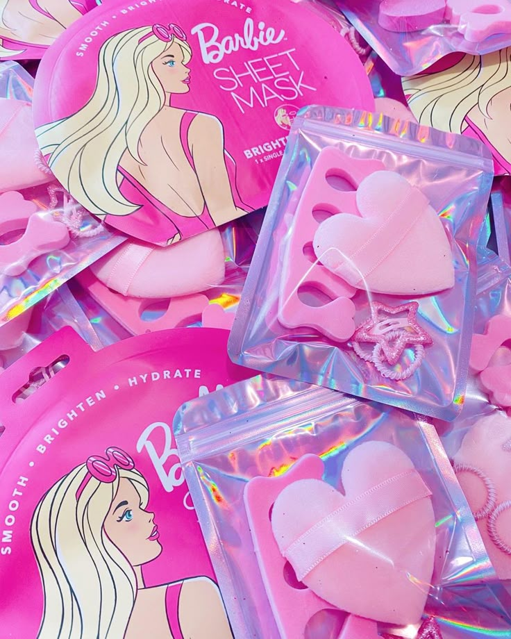 some pink heart shaped hair clips in plastic bags on top of each other with the words barbie