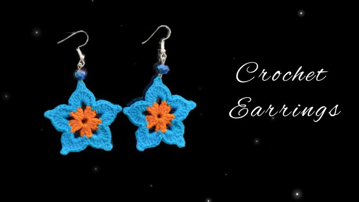 crochet earrings with an orange and blue flower in the center on a black background