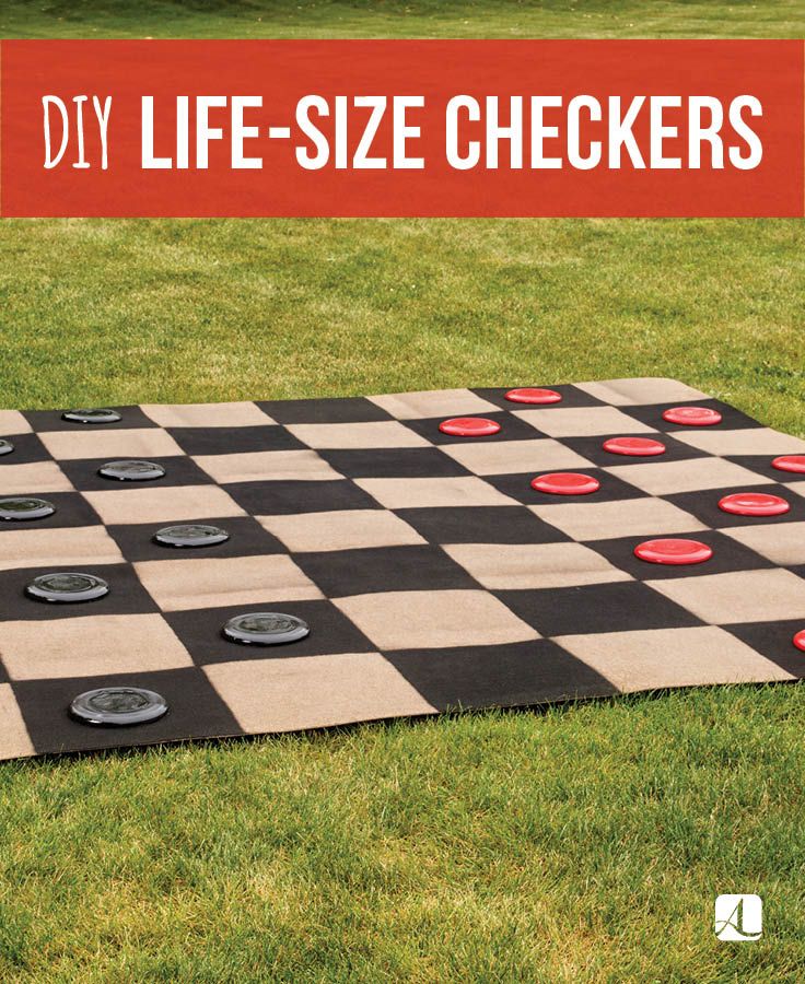 a black and white checker board laying on top of grass with the words diy life - size checkers over it