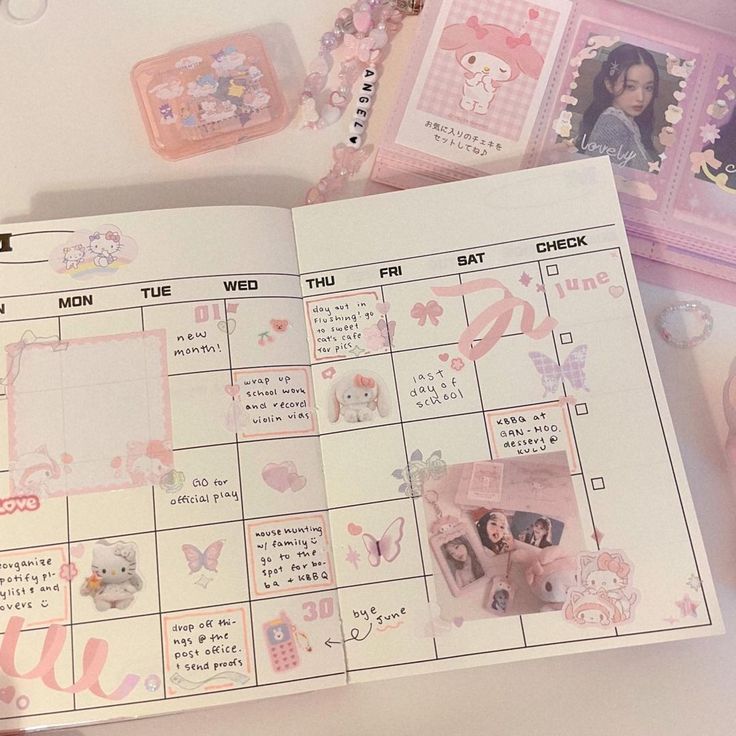 an open planner book with pictures and stickers on the pages next to other items