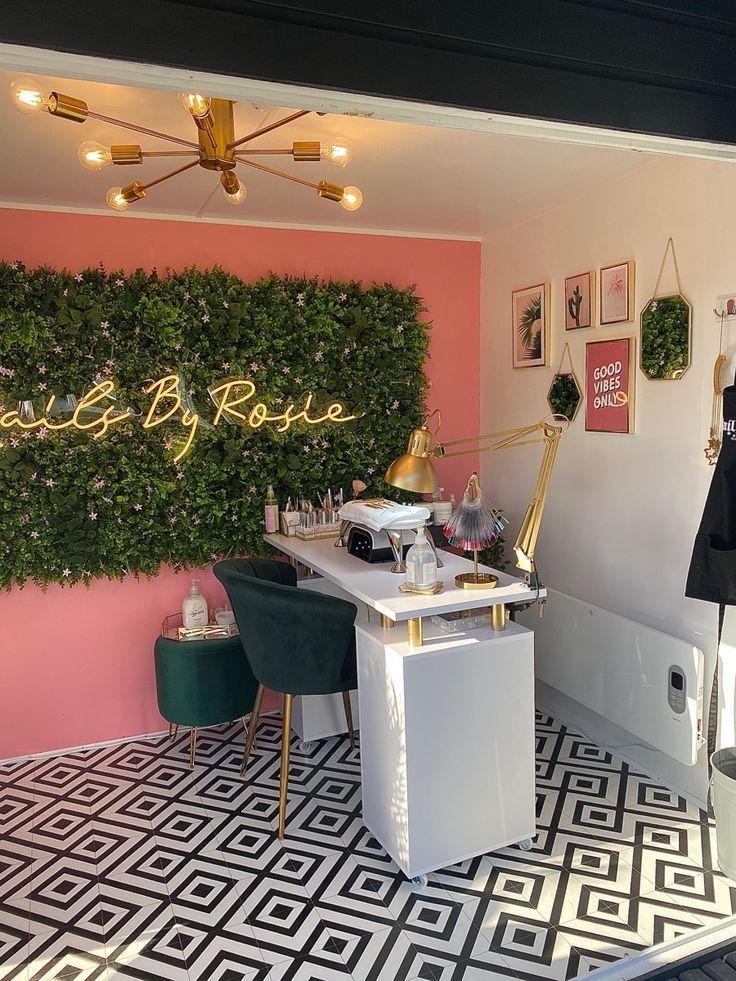 a room with pink walls, black and white flooring and green plants on the wall