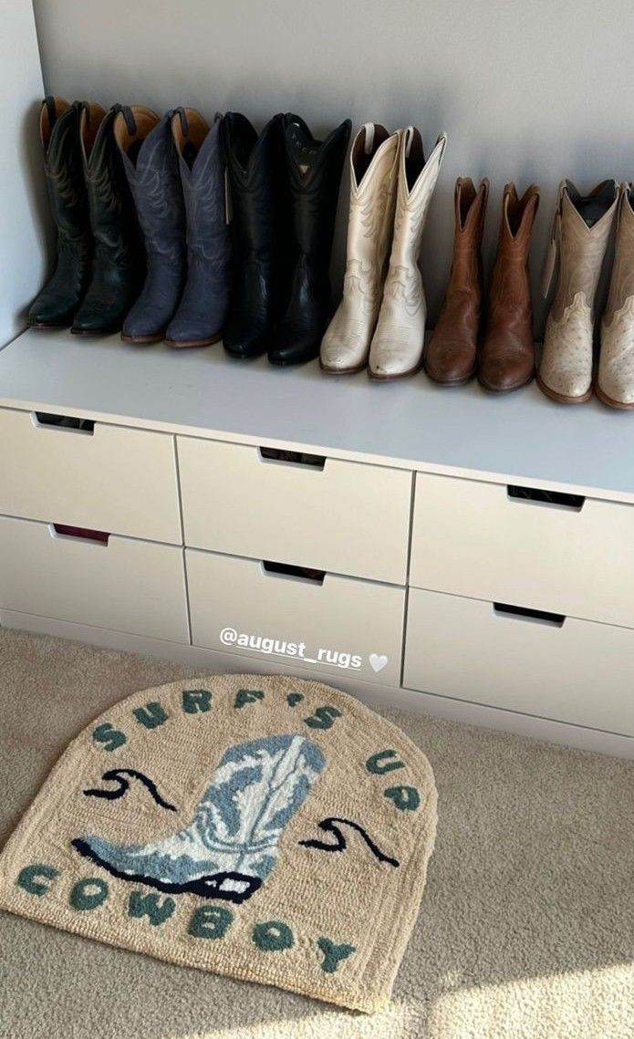 there are many pairs of shoes on the floor in front of a shelf with drawers