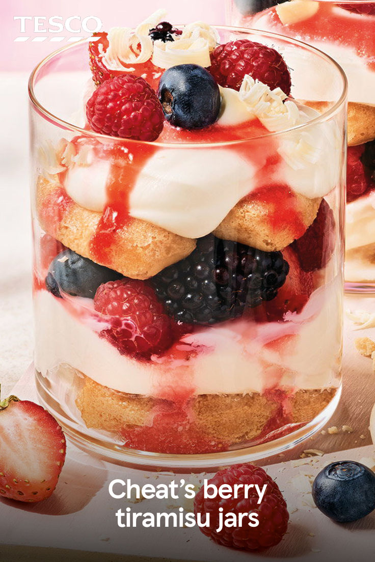 an advertisement for tesco featuring berries and cream in a glass container with strawberries