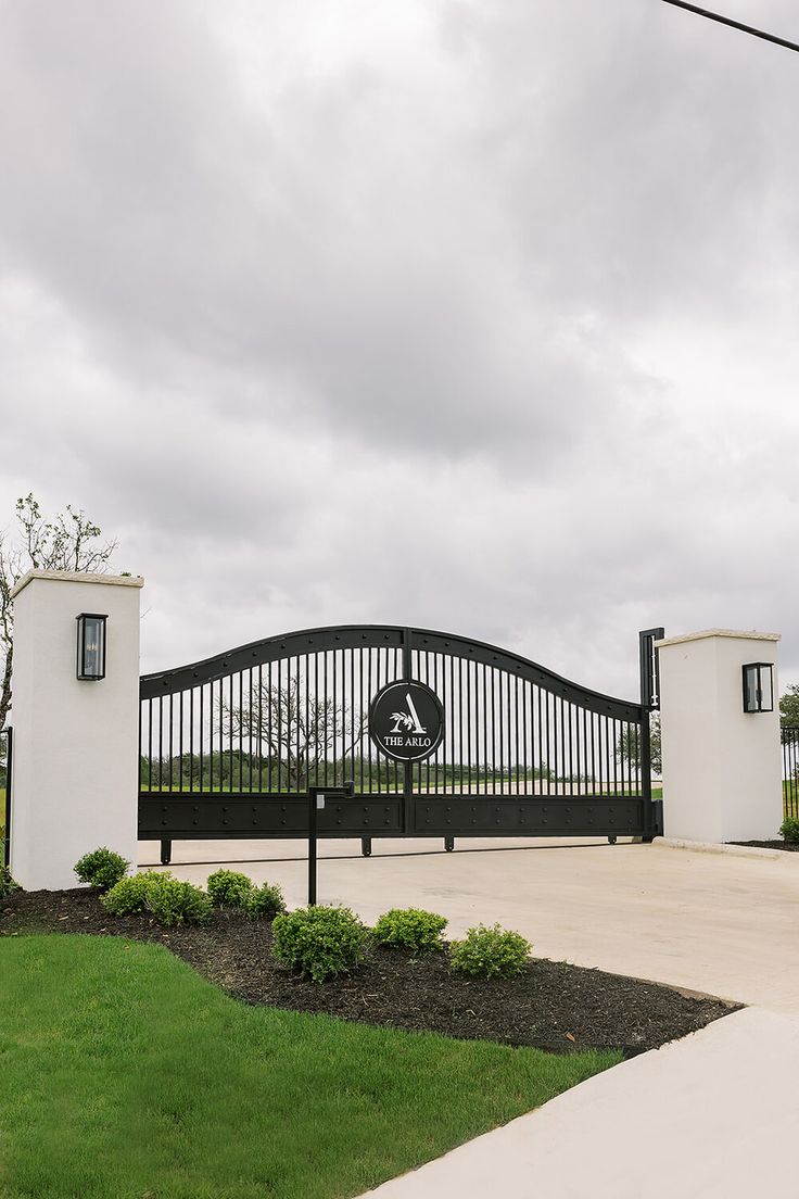 a black and white gate with a clock on it