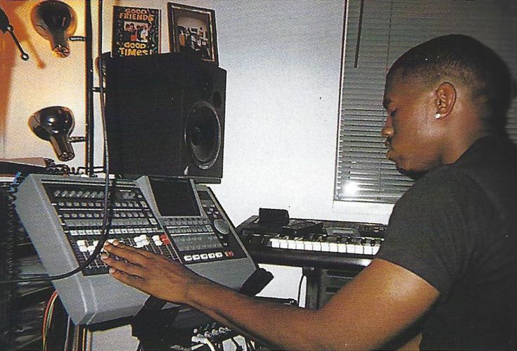 a man sitting in front of a mixing desk