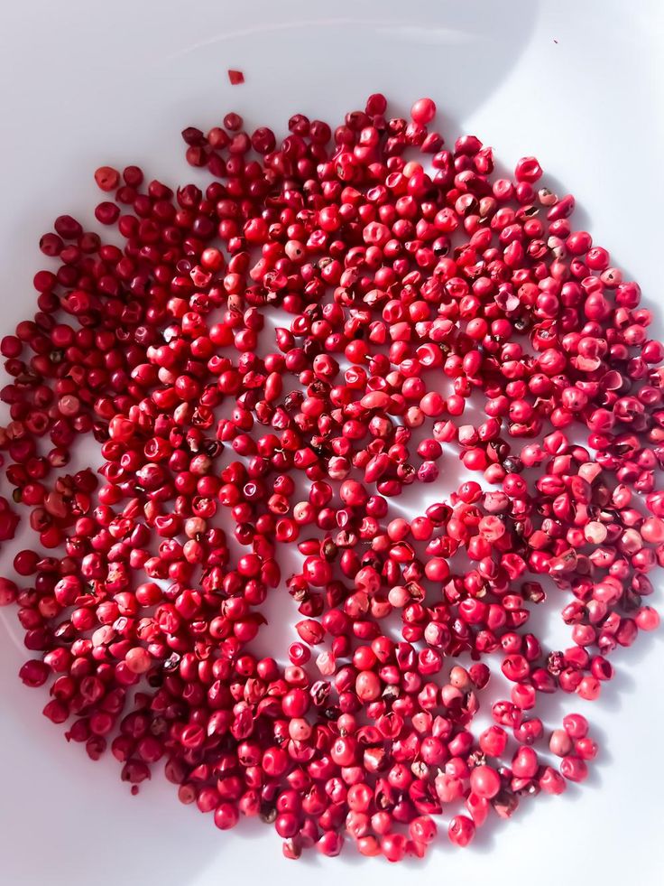 a white plate topped with lots of red berries