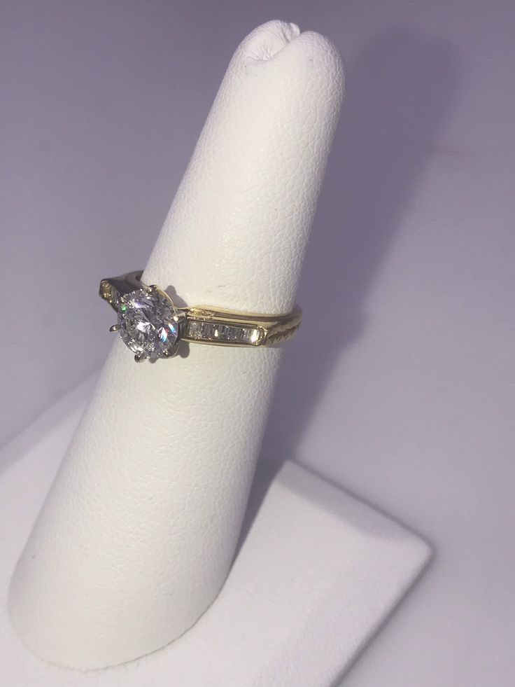 14k yellow gold Diamond Engagement Ring. Center Diamond is .98 ct. I1 clarity, I color, Baguettes total weight .15ct. Size 6 1/4, Circa 2000-2009 Classic Round Cut Diamond Ring Stamped 14k, Gold Baguette Cut Diamond Ring With Vvs Clarity, Classic Round Cut Diamond Ring, Gold Baguette Cut Diamond Ring, Gold Diamond Ring With Baguette Cut And Diamond Accents, Gold Diamond Ring With Baguette Cut Accents, Heirloom Diamond Ring Stamped 14k, 14k Gold Diamond White Diamond Ring, Diamond White 14k Stamped Round Cut Rings