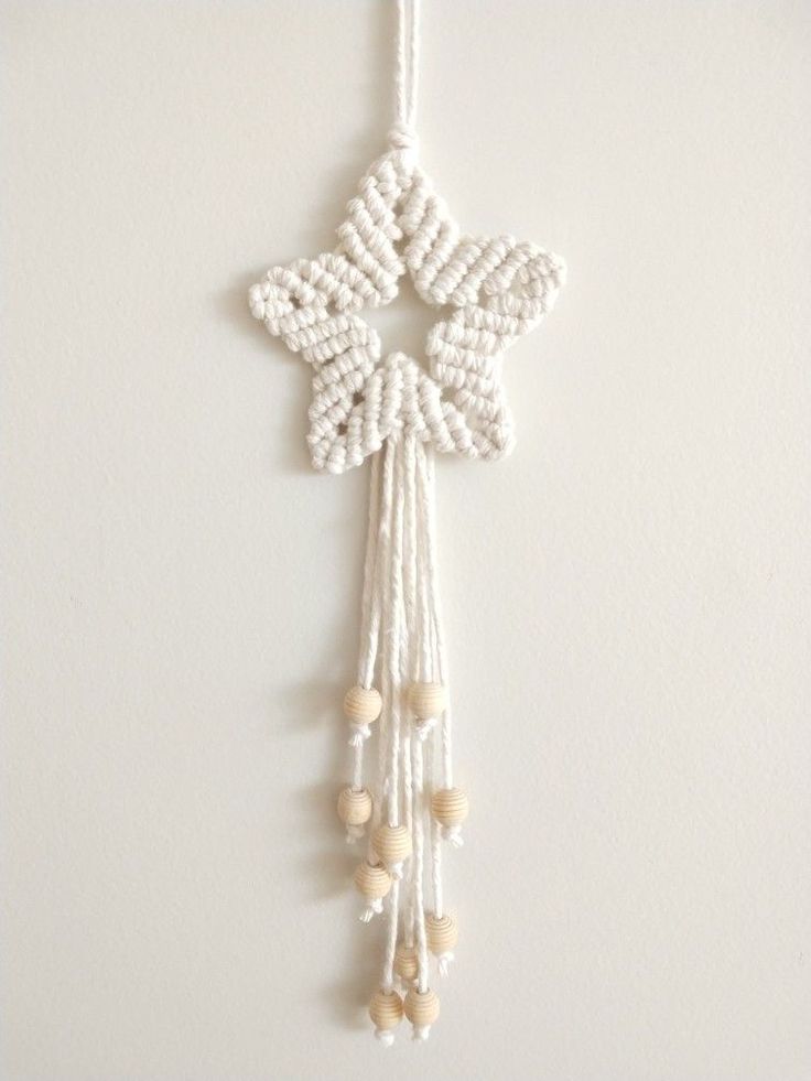 an ornament hanging on the wall with beads