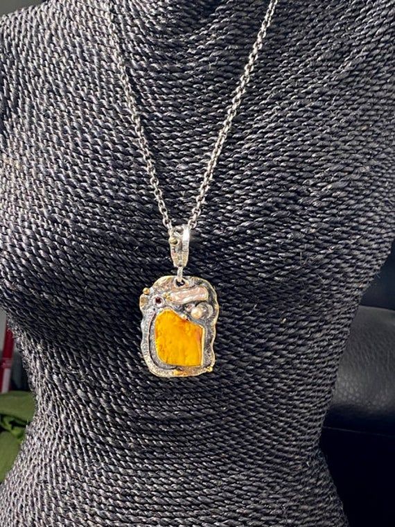 "Artisan Amber gemstone pendant Hand-made Sterling Silver 925,24k Gold Stones used: Baltic Amber, Pearls, Garnet Height - 3\" (with bail), Width - 1 1/2\" Height -75mm (with bail), Width - 38mm Unique Handcrafted One-of a-kind Design Pendant Each Piece of Jewelry in my Collection is Absolutely One of a Kind! When you start wearing a piece of my jewelry you will fall in love with it more and more each day and feel that good Energy and Love that I pass into it while creating this piece of Art. A p Yellow Gemstone Fusion Jewelry, Luxury Hammered Pendant Jewelry, Yellow Fusion Gemstone Jewelry, Yellow Fusion Style Gemstone Jewelry, Amber Hallmarked Necklaces For Gifts, Amber Necklace Hallmarked For Anniversary, Amber Hallmarked Necklace For Anniversary, Yellow Necklace With Large Round Pendant, Hammered Square Pendant Jewelry As Gift