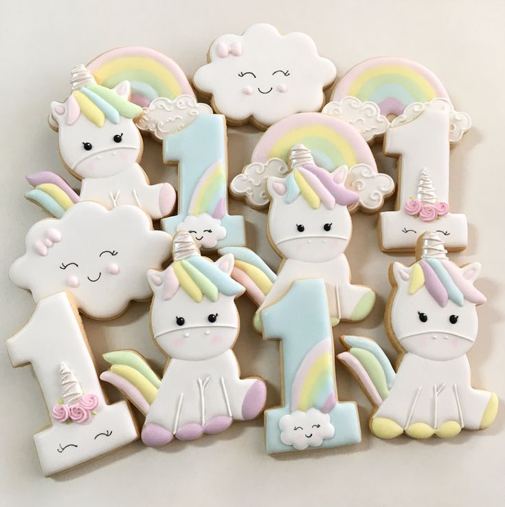 decorated cookies in the shape of unicorns and rainbows are arranged next to each other