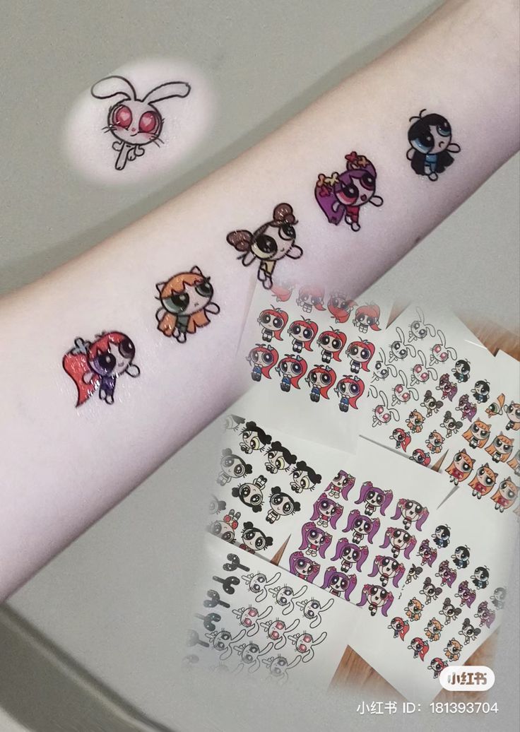 a person's arm with many stickers on it and one has an animal