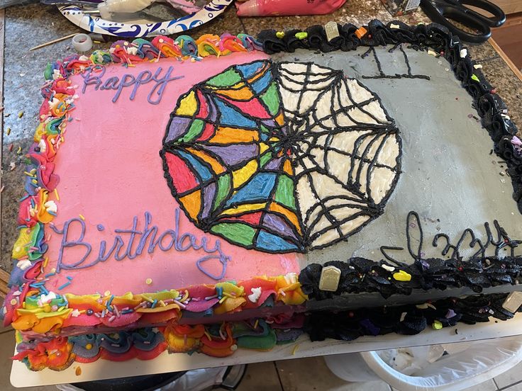 a birthday cake that has been decorated to look like a spider web