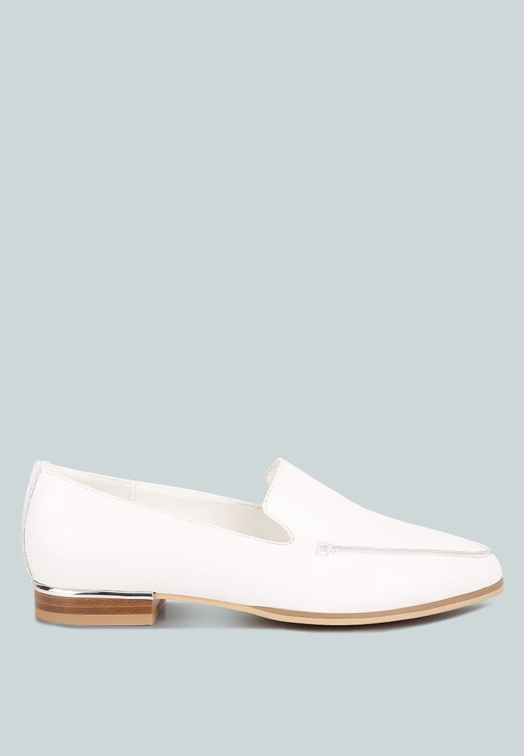 The minimalist loafers are a classic versatile style and ideal as office shoes that look elegant and chic. The metallic sling adds a bling feature that looks luxe. The loafers are comfortable to wear with soft cushion insoles. Upper Material: Genuine Leather Outer sole: Rubber Closed Pointed Toe Metallic Sling Detail Lightly Cushioned Insole Flat Heels RCSH4053 Modern White Slip-ons For Work, Chic White Slip-ons For Office, Modern Spring Flats For Office, Elegant White Slip-ons For Office, Modern White Flats For Work, Classic Flats With Metal Feet For Work, Modern Slip-on Flats For Office, Elegant Slip-ons For Office In Spring, Sleek Spring Loafers For Office