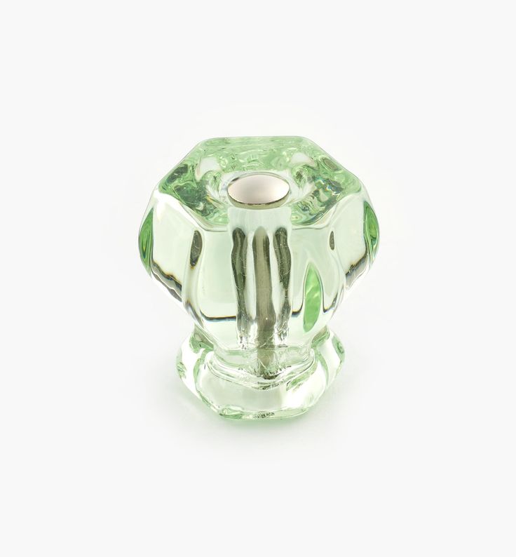 a green glass bead on a white background