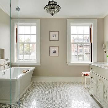 a bathroom with two windows and a bathtub