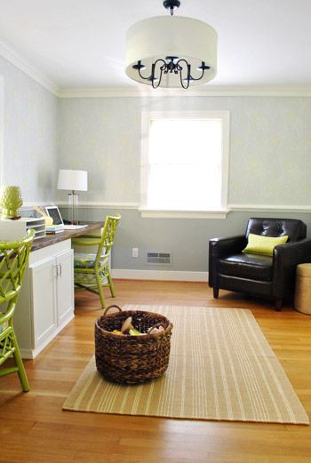 a living room filled with furniture next to a kitchen and dining room table in front of a window