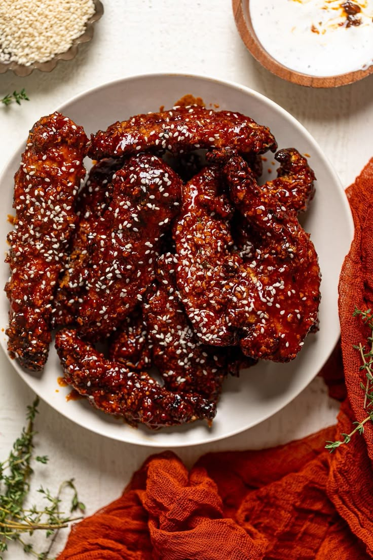 a white plate topped with meat covered in sauce