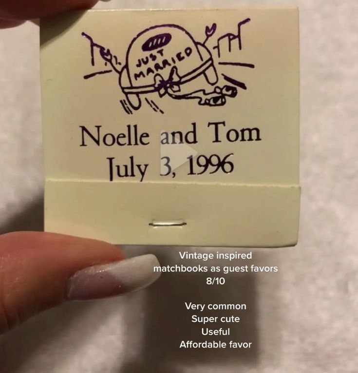 a person holding up a small card with the words noelle and tom july 3, 1965