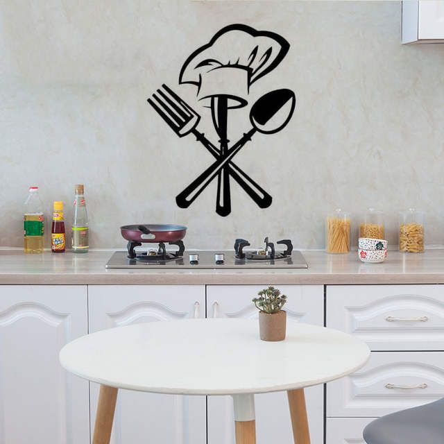 a wall sticker with a chef's hat and spoons on the kitchen counter