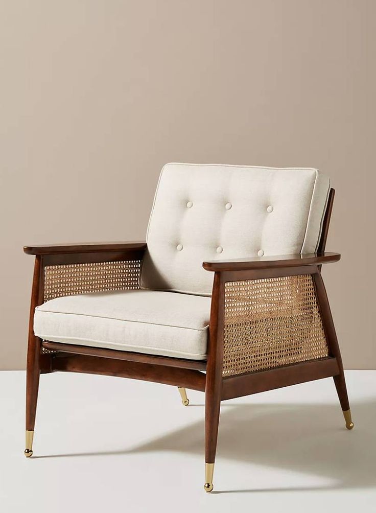 a white chair sitting on top of a white floor next to a beige wall in an empty room