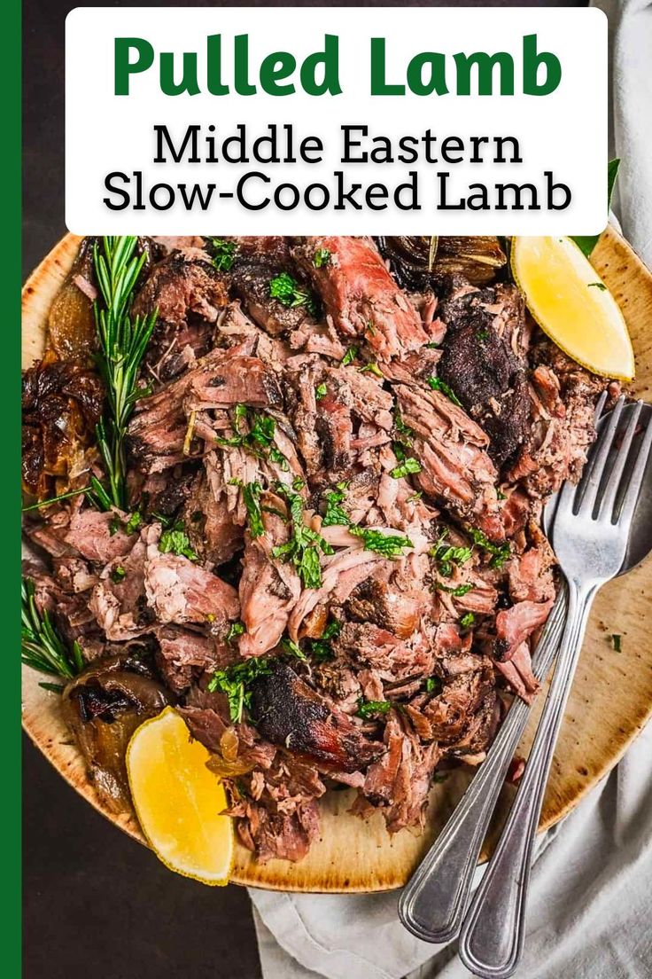 pulled lamb in a bowl with lemons and parsley on the side next to a fork