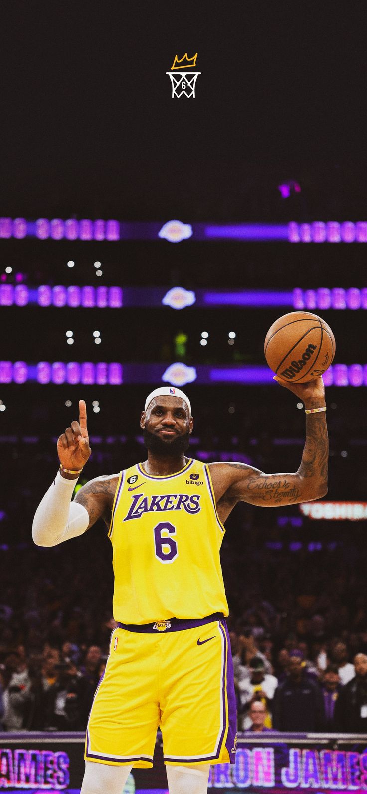 a basketball player holding a ball in one hand and making the peace sign with his right hand