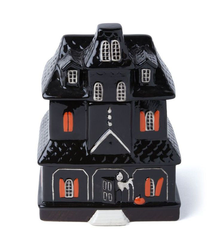 a black and orange house shaped candle holder