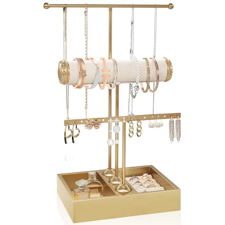 a gold jewelry stand with bracelets, earrings and rings hanging from it's sides