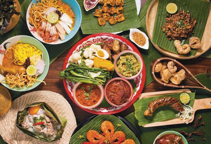 a table topped with lots of different plates and bowls filled with various types of food