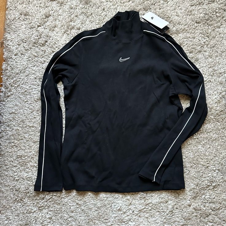 Nwt Nike Long Sleeve Mock Turtleneck Shirt. Slim Fit. Ribbed Material. Never Worn And In Great Shape. Size Women’s Xl. Black Shirt With White Piping Detail On Sleeves And Nike Logo On Front Top Center. Nike Fitted Long Sleeve Tops, Nike Sporty Long Sleeve Top, Nike Sporty Tops For Fall, Sporty White Turtleneck Top, Winter Sporty Turtleneck Tops, Nike Fitted Winter Tops, Nike Stretch Winter Tops, Fitted Nike Tops For Winter, Winter Nike Stretch Tops