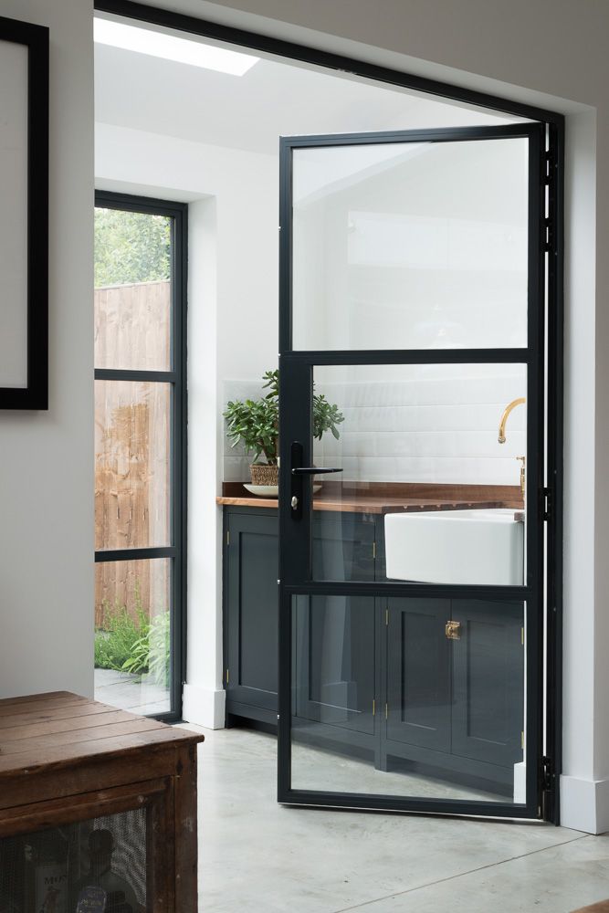 an open glass door leading to a kitchen