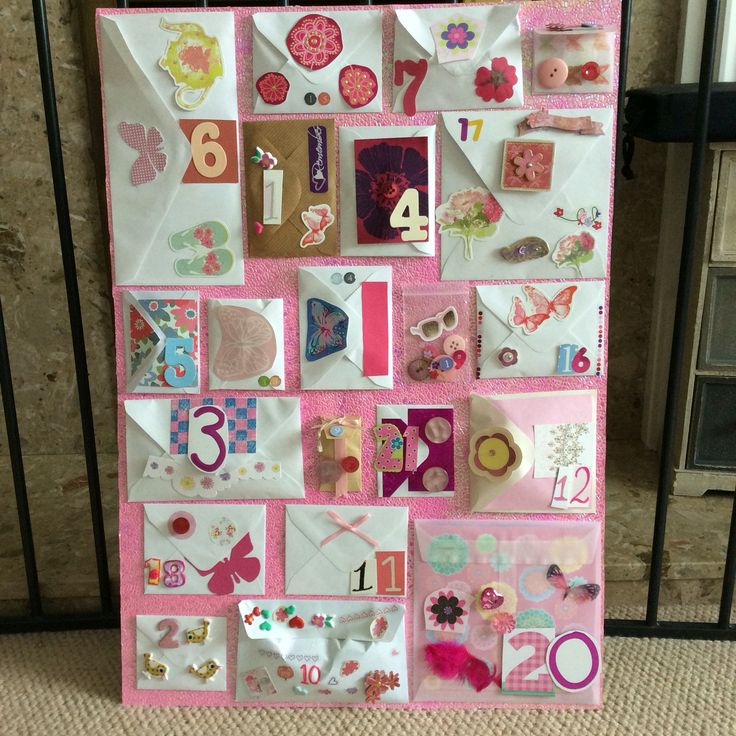 a pink and white wall hanging with lots of magnets on it's side