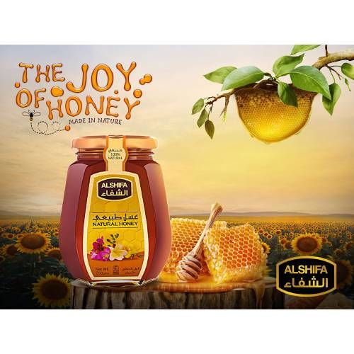 a jar of honey sitting on top of a tree stump next to a bunch of sunflowers