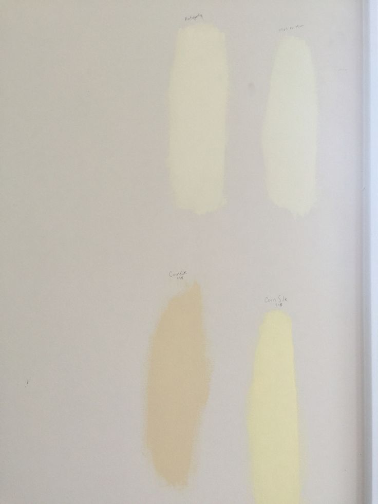 four different shades of yellow paint on a white wall