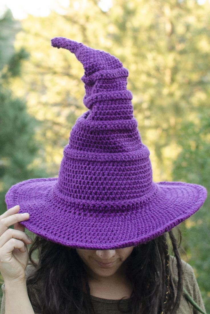 a woman wearing a purple crocheted witches hat