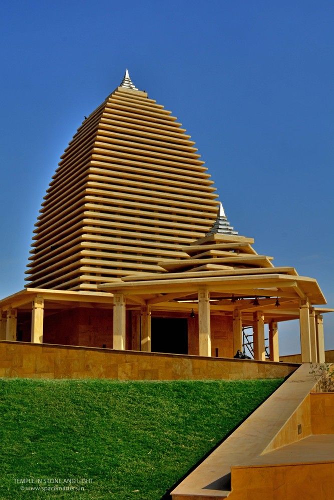 a large wooden structure sitting on top of a lush green field