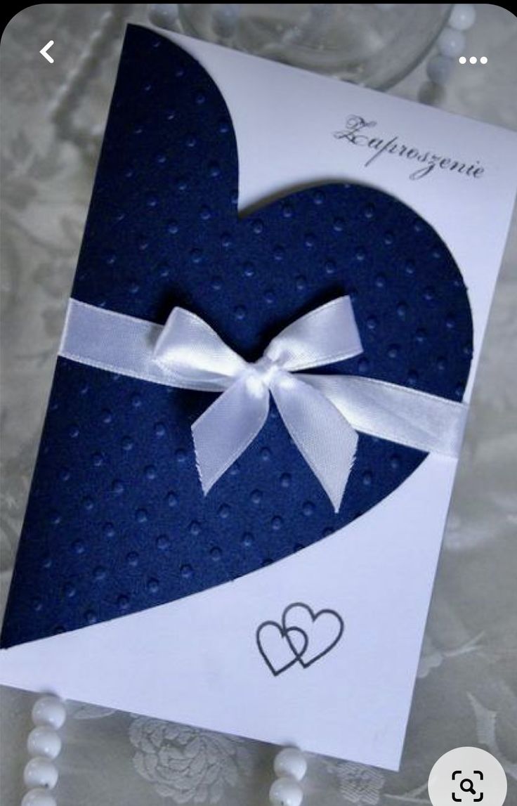 a heart shaped card with a bow on it