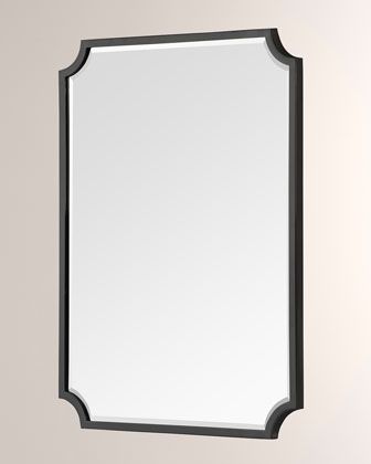 a mirror hanging on the wall with a black frame and silver trim around it's edge