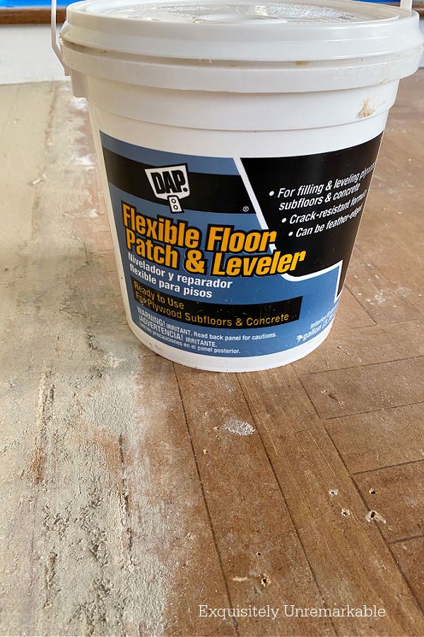 a bucket of flexible floor patch and leveler